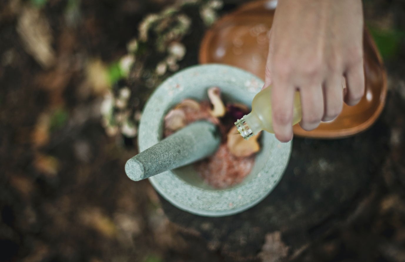 A herbalist mixing and crushing natural herbal ingredients to use for a medical treatment: Doctor of Naturopathy